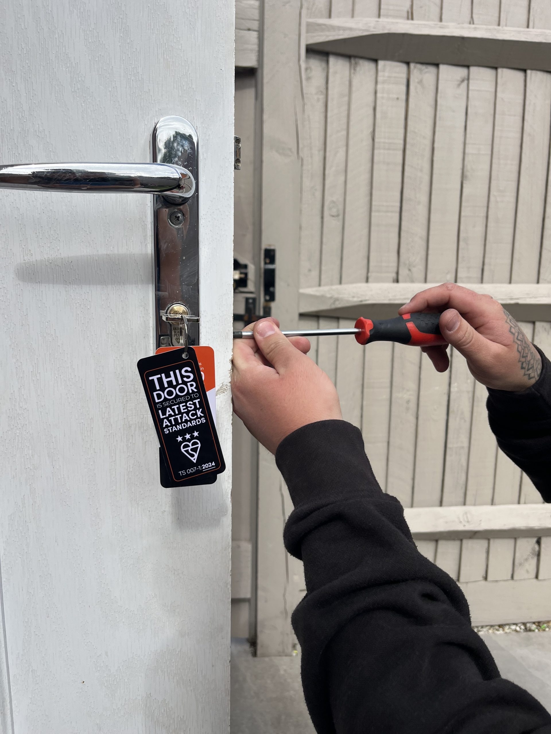 Close-up of Seymour Locksmiths fitting a secure door lock to meet latest attack standards