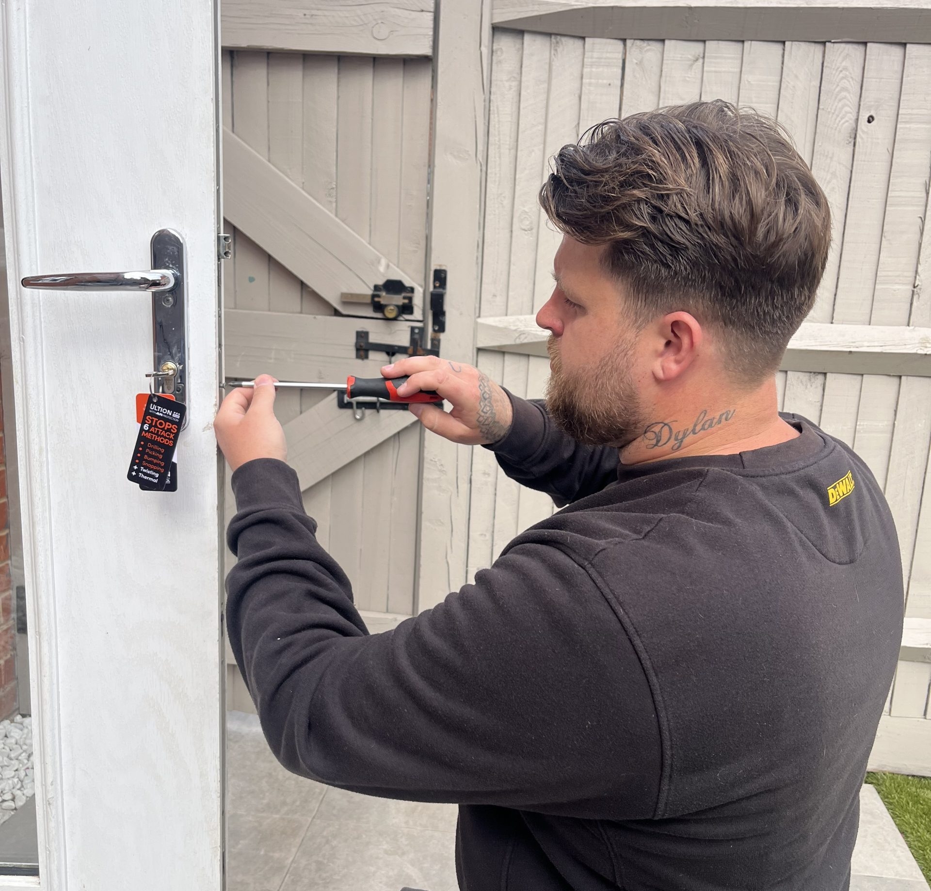 Seymour Locksmiths locksmith Connor working on a door lock with a screwdriver